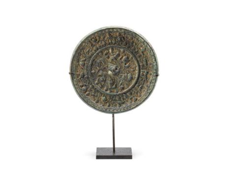 A large Chinese bronze 'Mythical Animals and Grapes' mirror, Tang Dynasty (618-907), cast with a crouching-lion knop in the c