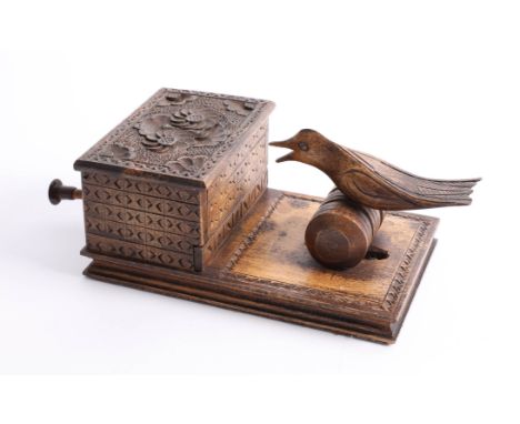 A vintage novelty wood bird cigarette dispenser.