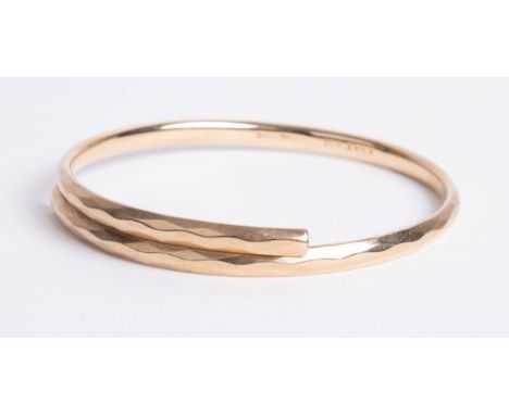 A modern gold plated bangle.