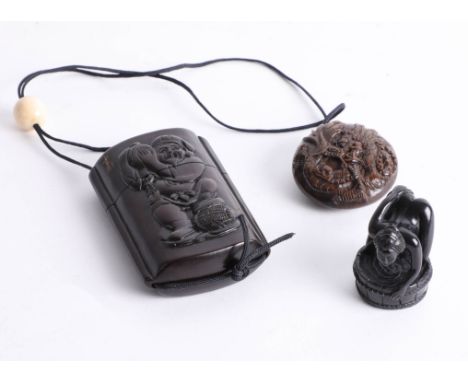A Japanese inro depicting a man carrying a barrel and a netsuke depicting a dragon, and an erotic netsuke depicting a woman b