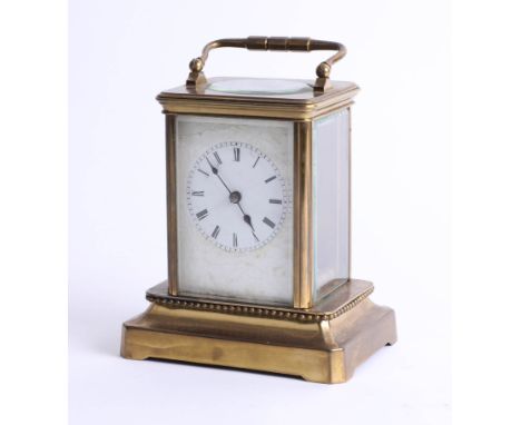 A brass carriage clock on base, maker unknown, height 15cm.