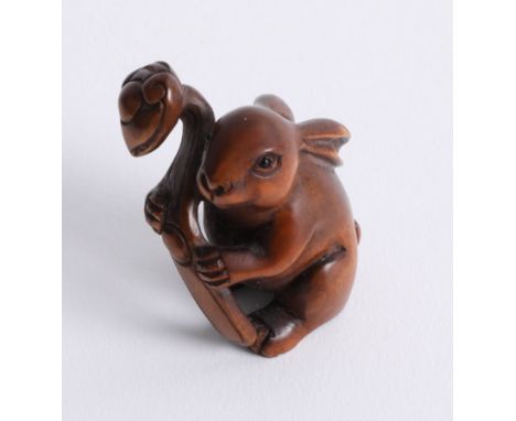 A carved wood netsuke, depicting a Hare.