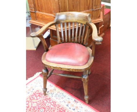 A vintage oak framed desk chair.