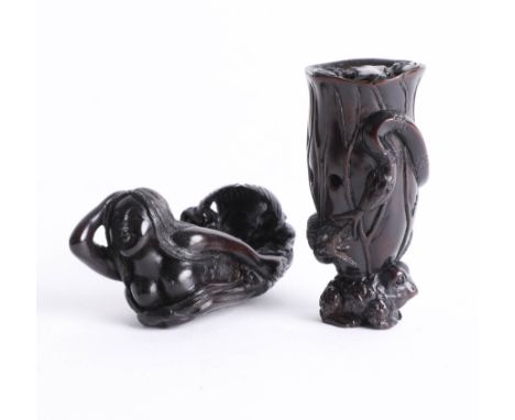 Two Japanese dark wood netsukes, one depicting two frogs and a tree trunk and the other depicting a mermaid. Both signed.