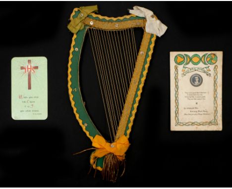 A Christmas card from Sean McGarry to Kathleen Clarke, a memorial card for Kathleen Clarke and a craftwork harp. The Christma