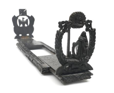 Late 19th century bog-oak book trough by Cornelius Goggin. A finely carved Victorian sliding book trough, the base centred by