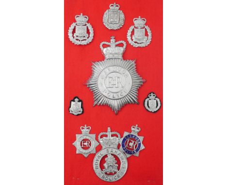 Royal Ulster Constabulary Chief Superintendent's uniform cap and a collection of police helmet plates and badges. The collect