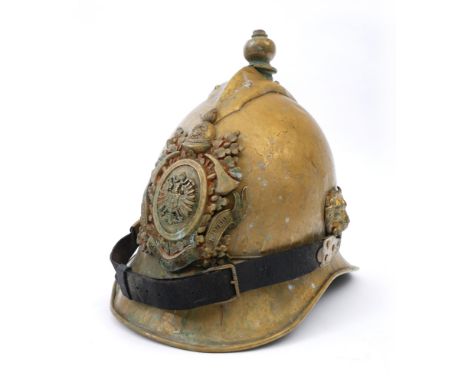 19th century German brass firefighter's helmet. The scalloped comb with ball finial above German Imperial helmet plate, the c