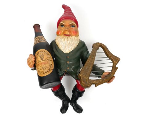 1961 Guinness leprechaun, truck ornament. A figure of a leprechaun dressed in a red pointed hat, green coat and red trousers 