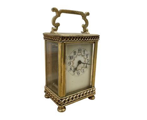 French- Edwardian 8-day carriage clock c1910, with recessed chain decoration and a serpentine handle, four recessed glass pan