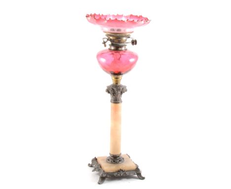 A pedestal oil lamp, with clear glass chimney, Cranberry glass reservoir, alabaster column, 78cm.