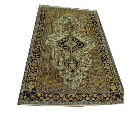 A Caucasian pattern rug, central medallion with pendant medallions, on an ivory coloured field, border within guards, 260cm x