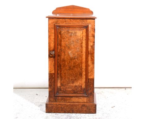 A Victorian burr walnut pedestal cupboard, shallow back, the top with a moulded edge, panelled door enclosing a shelf, plinth