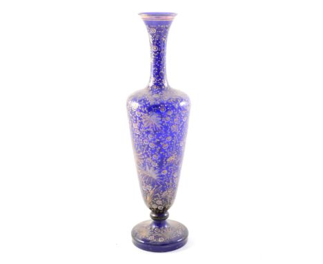 A blue glass vase, gilt and enamel decoration of flowers and foliage, 36cm.