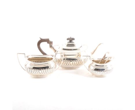 A silver matched three-piece teaset, half-fluted design, gadrooned rim, teapot by Mappin &amp; Webb, Sheffield 1913, sugar bo