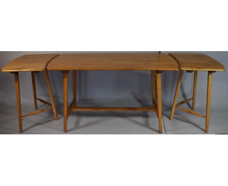 A 1970's Ercol Elm and Beech Dining Table with Two Extensions Pieces on Tapering Supports