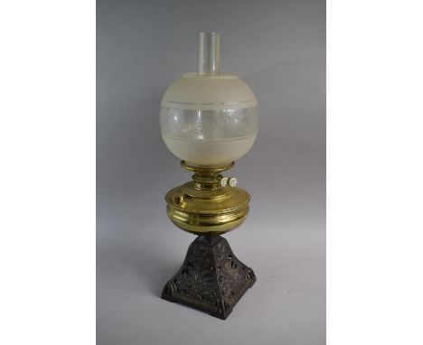 A Late Victorian Pierced Iron Oil Lamp with Brass Reservoir, Chimney and Shade 