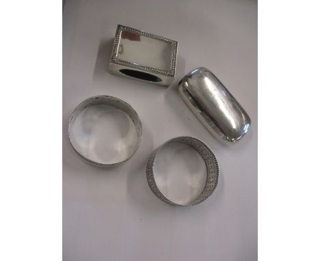 Two silver napkin rings, a matchbox case, and a late 20th century silver snuff box, weight 90.2g Location: Porters 