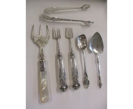 Small silver items to include sugar tongs, total weight of silver items excluding mother of pearl handled fork 102.8g Locatio