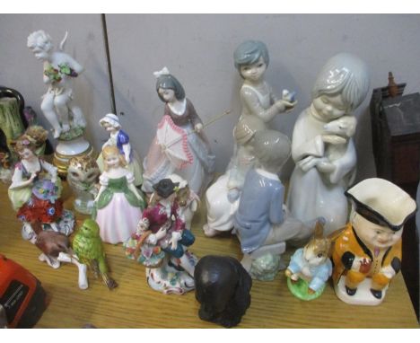 A selection of figures and ornaments to include Lladro, Nao, Beswick, a bust of Winston Churchill signed Oscar Neman and othe