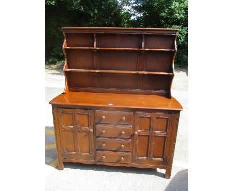 A vintage Ercol dark stained dresser with plate rack 