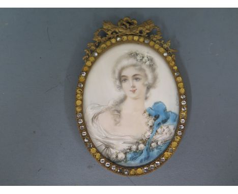 A miniature portrait of a young classical lady in an oval gilt frame - 12cm x 7.5cm 