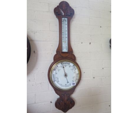 A carved oak barometer/thermometer - Height 85cm