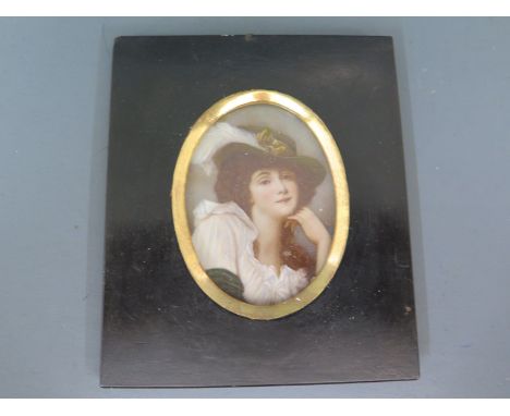 A miniature portrait of a classical lady wearing a hat in an oval gilt frame on ebonised board background - 11cm x 13cm 