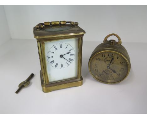 A brass carriage clock and a Zenith Watch Co alarm clock - both needing attention