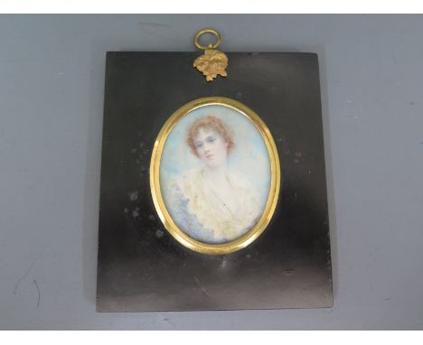 Alyn Williams - a miniature portrait in an oval gilt frame on ebonised board background of a young lady - 8cm x 6.5cm 