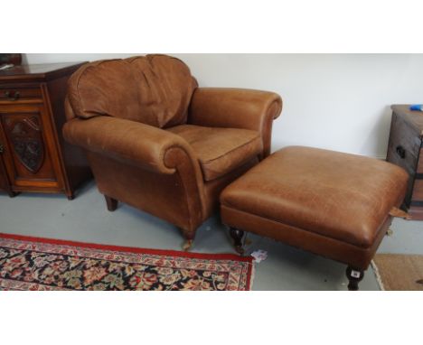 A Laura Ashley distressed leather armchair and stool with a lift up top