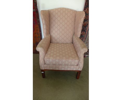 A modern reproduction wing armchair