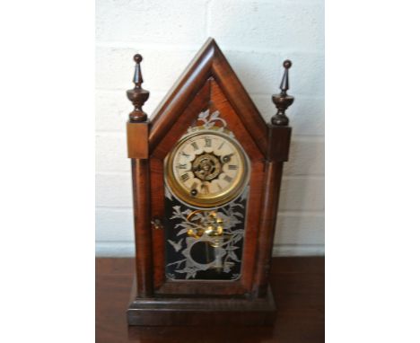 An American steeple clock, glazed panel showing birds, alarm movement strikes on a bell - Height 40cm - working in the sale r