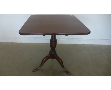 A Victorian oak tip up table on tripod base