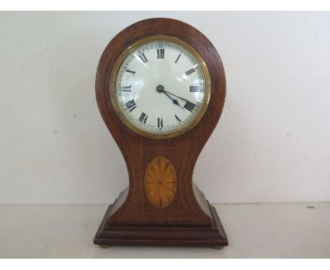 A mahogany and inlaid cased balloon clock, white enamel dial with Roman numerals with Swiss Buren movement 