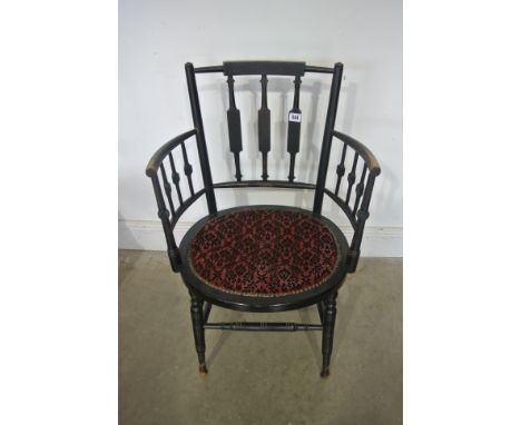 An Arts and Crafts ebonised armchair in the style of William Morris