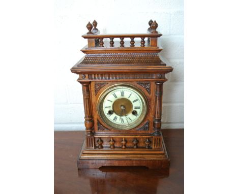 A 14 day mantle clock by HAC strikes hours and half on gong in an oak case with galleried top - Height 35cm - working in the 
