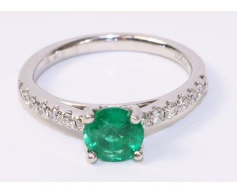 Platinum ring set with an emerald and seven diamonds to each shoulder hallmarked   Condition Report   Click here for further 