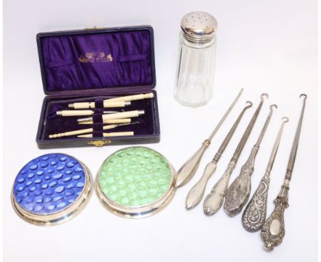 Collection of Victorian silver handled button hooks, two silver rimmed glass coasters, sugar shaker, bone dip pen, needle cas