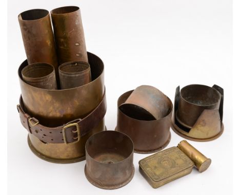 Two pairs of brass shell cases, a small trench art example, another large litter bin shell case, a metal sword scabbard, a Sa