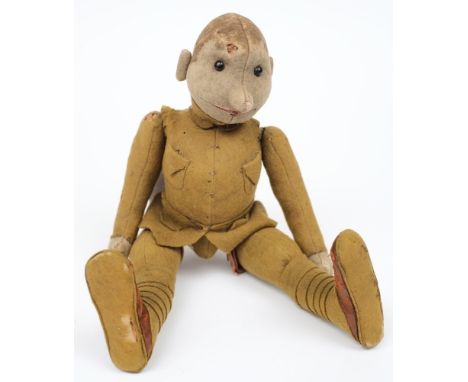 A WWI period felt doll of a British soldier:, unsigned, boot button eyes, dressed in period uniform with articulated limbs, s