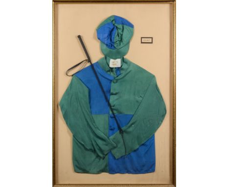 A set of green and blue racing silks, cap and whip for E B Glen:, mounted and framed in a glazed case, 112cm x 73cm.