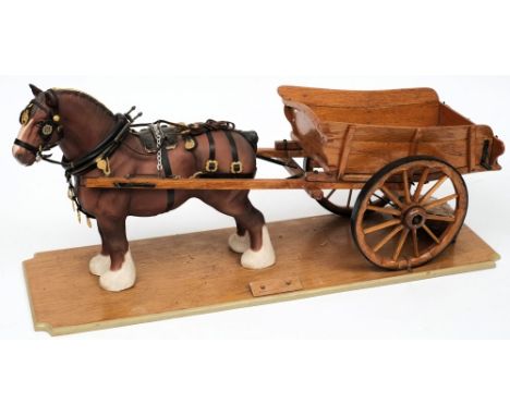 A Beswick model of a Shire horse mounted with a scale model of a hay cart on a wooden plinth:, the cart inscribed 'J W German