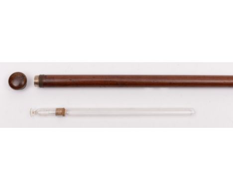 A Victorian gentleman's tipple stick:, the knurled copper cap unscrewing to reveal a concealed clear glass phial (24cm) and f