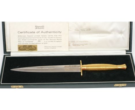 A cased Wilkinson Sword commemorative commando knife:, the 18cm double edged polished blade etched with 'United we Conquer' a