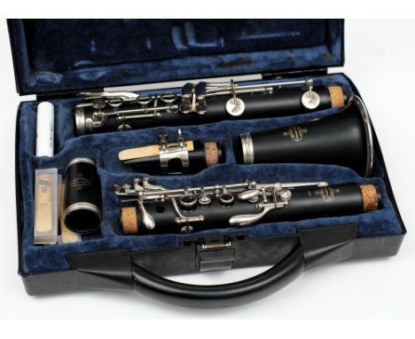 An ebony five section clarinet by  Buffet Crampon & Cie, Paris: contained in a fitted case and accessories.