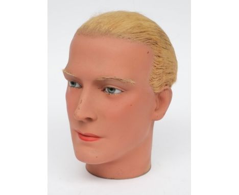 An early 20th century male wax mannequin head:,  with real hair, glass eyes and painted face, circa 1930/40, 26cm high