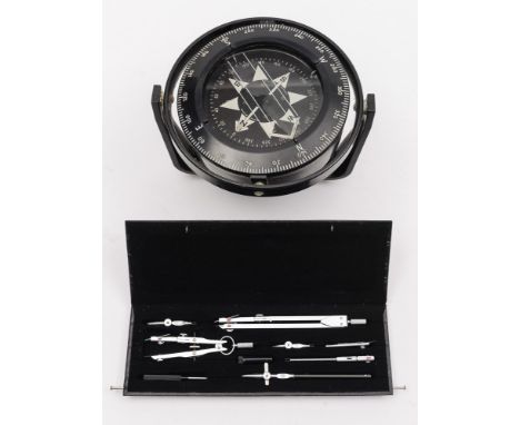 A gimbal mounted liquid filled compass:, 15cm diameter, by Heath Marine, London, black plastic mount and casing, together wit