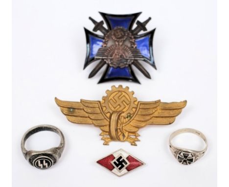 A Third Reich period National Socialist Party enamel badge, together with two rings, an enamel cap badge and a drivers token:
