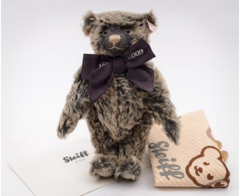 Steiff - A 100 year anniversary black plush bear:, stitched snout, felt pads, glass eyes and jointed body, with purple bow ti